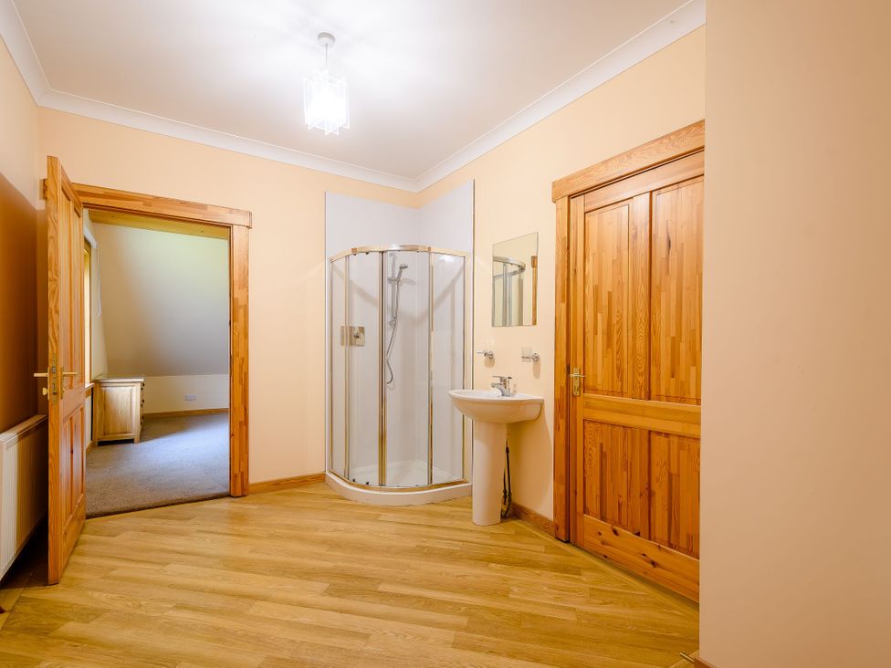 A bathroom with a shower and sink at Foresters Spa Plus (Pet) Dundee