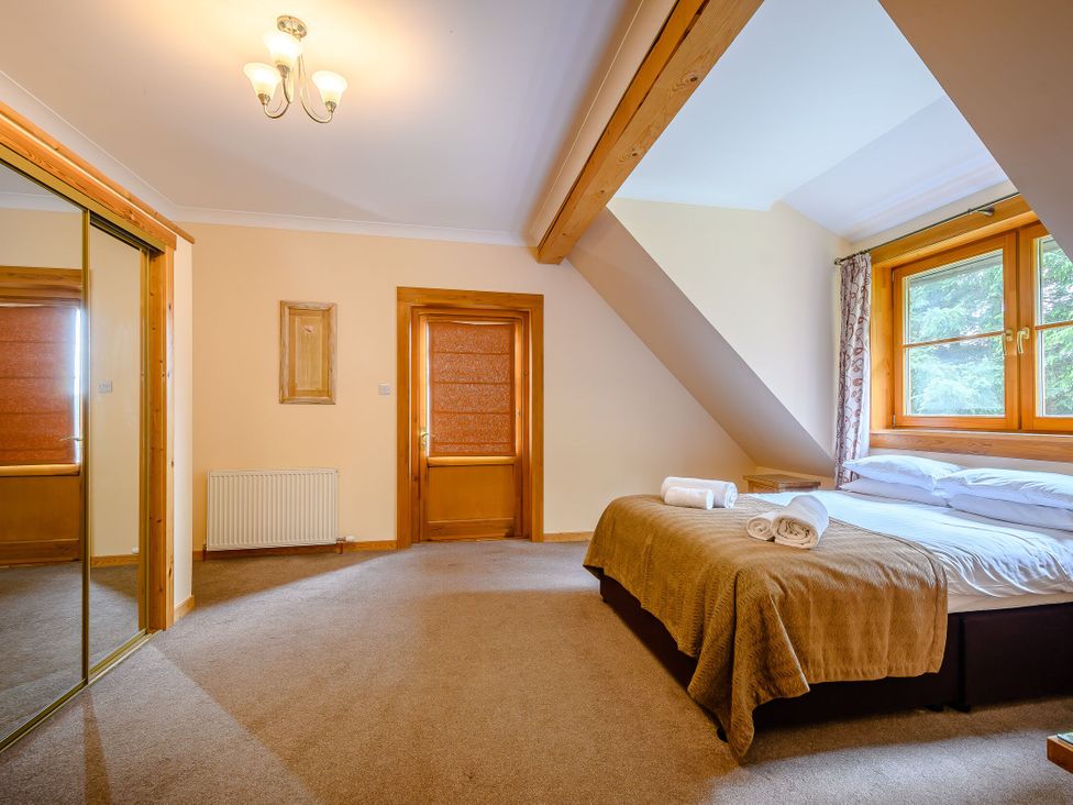 A bedroom with a bed and towels on it at Foresters Spa Plus (Pet) in Dundee