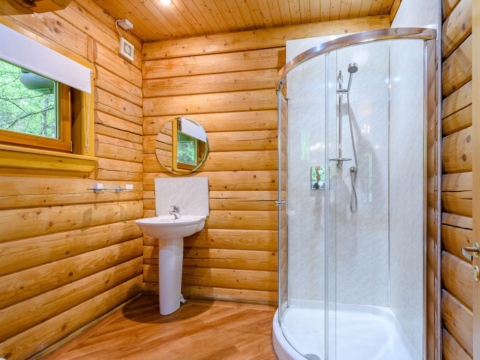 A bathroom with a shower and sink at Eagle Spa Plus (Pet) in Dundee