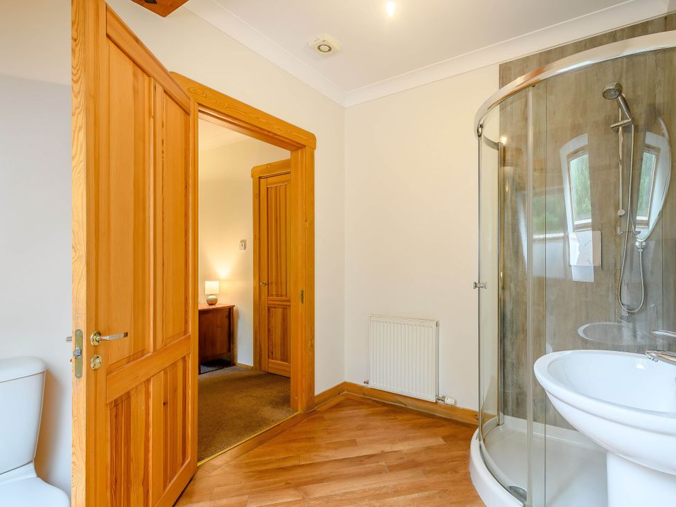 A bathroom with a shower, sink, and toilet at Eagle Spa Plus (Pet) in Dundee