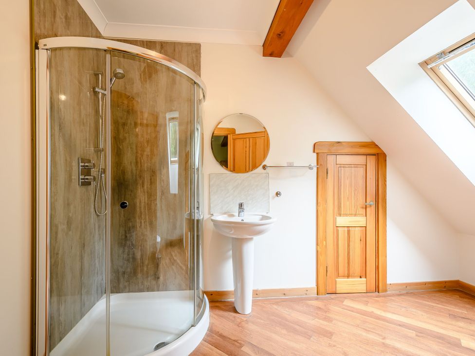 A bathroom with a shower and sink at Eagle Spa Plus (Pet) in Dundee