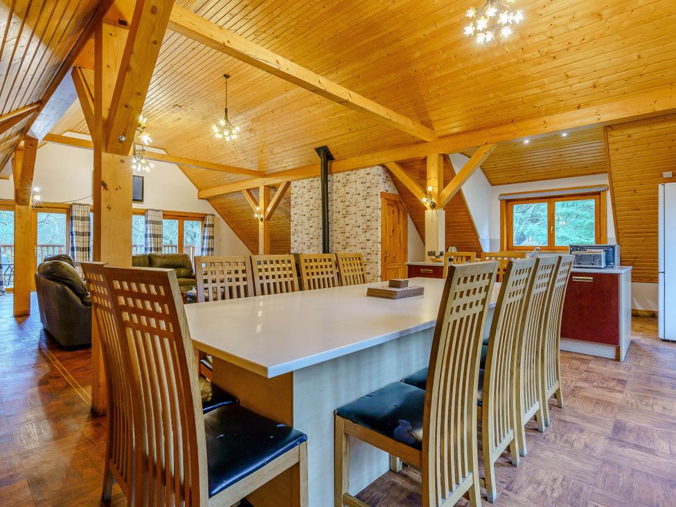 A dining room with a long table and chairs at The Braveheart in Dundee