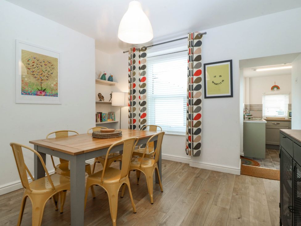 A dining room with a table and chairs at Mona Lodge in Llandudno