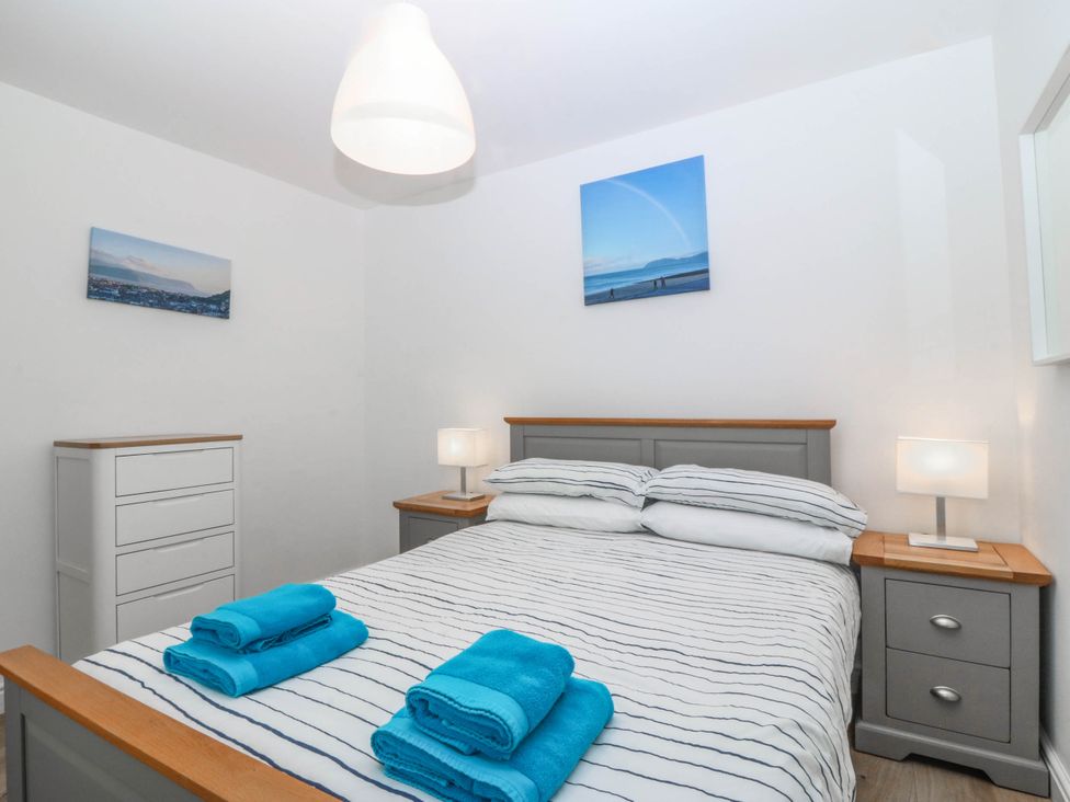A bedroom with a bed and dresser at Mona Lodge in Llandudno