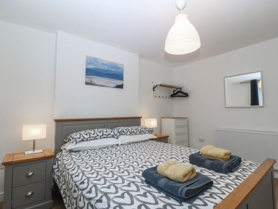 A bedroom with a bed and bedside tables at Mona Lodge in Llandudno