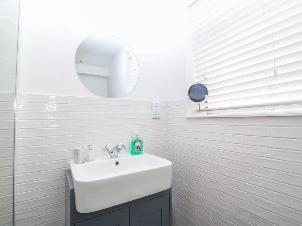 A bathroom with a sink and mirror at Mona Lodge in Llandudno