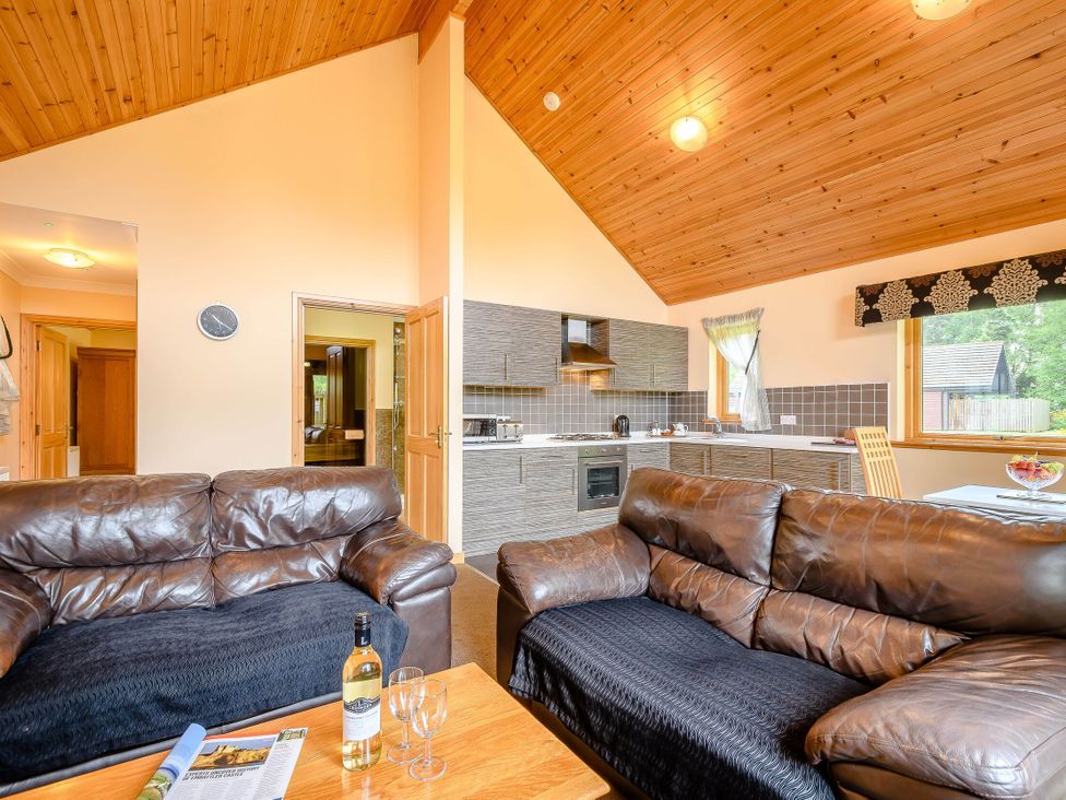 A living room with a sofa and coffee table at Muirloch Spa Plus in Dundee