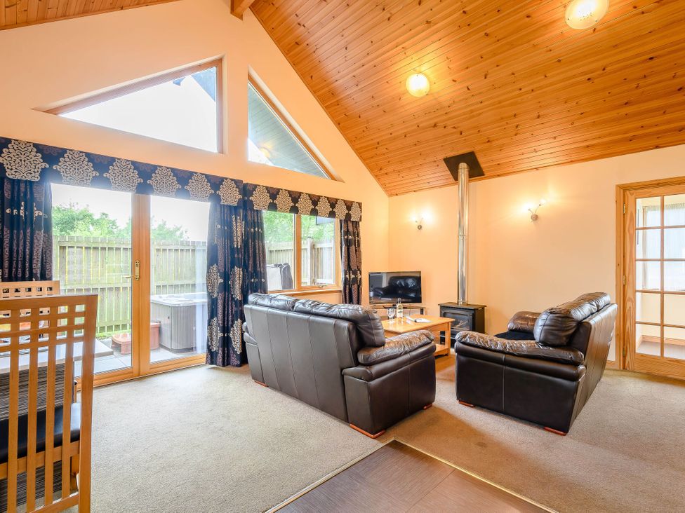 A living room with a sofa and coffee table at Muirloch Spa Plus in Dundee