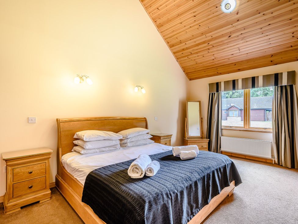 A bedroom with a bed and a window at Muirloch Spa Plus in Dundee