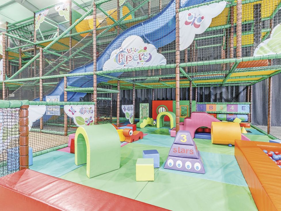 A play structure with slides and colorful foam shapes at Muirloch Spa Plus (Pet) in Dundee