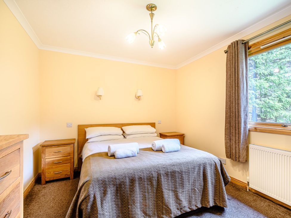 A bedroom with a double bed and nightstands at Barnard Lodge (Pet) Dundee
