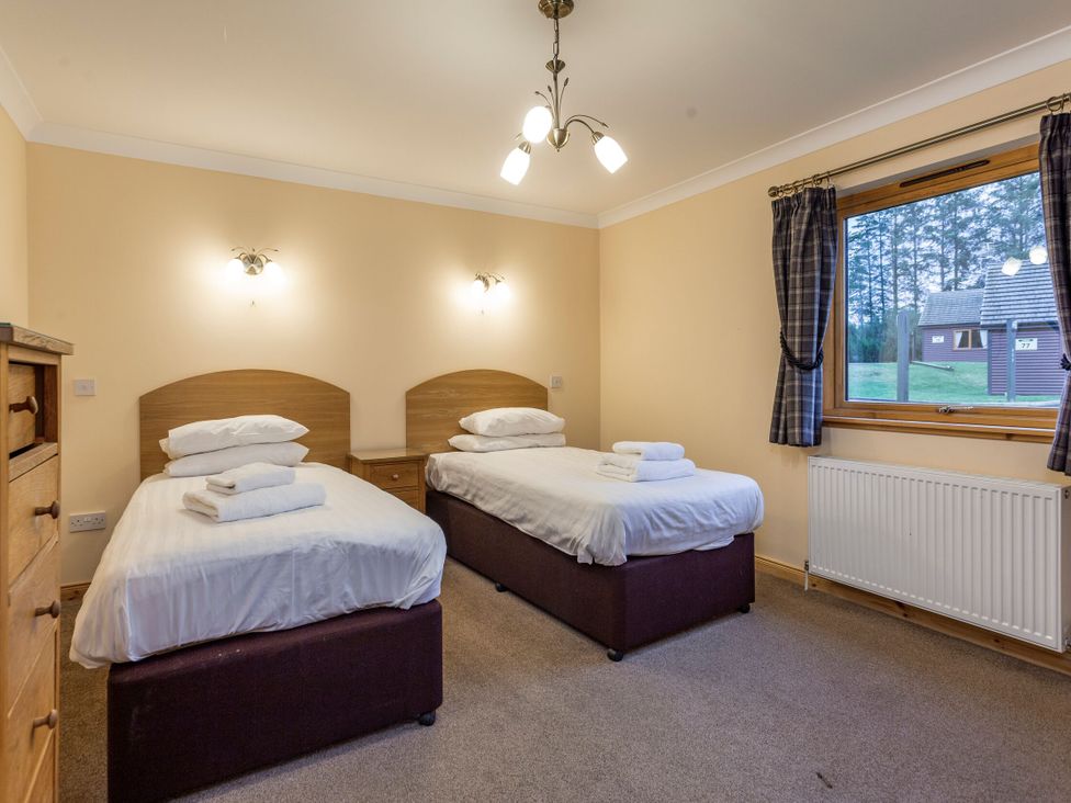 A bedroom with two beds and a window at Rainbow Spa Plus (Pet) in Dundee