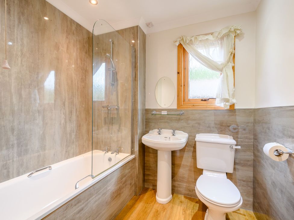 A bathroom with a shower and bathtub at Osprey Lodge Dundee