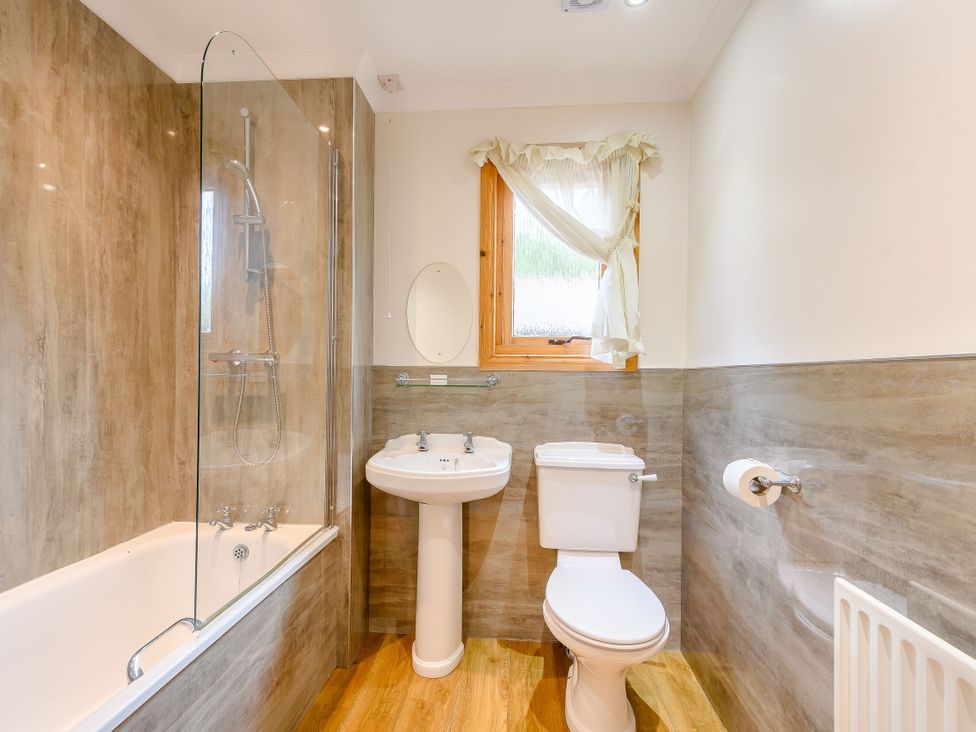 A bathroom with a shower and bathtub at Osprey Lodge in Dundee