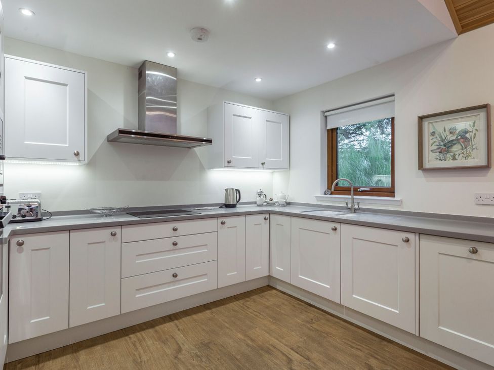 A kitchen with cabinets and a sink at Galbraith Premier Spa in Dundee