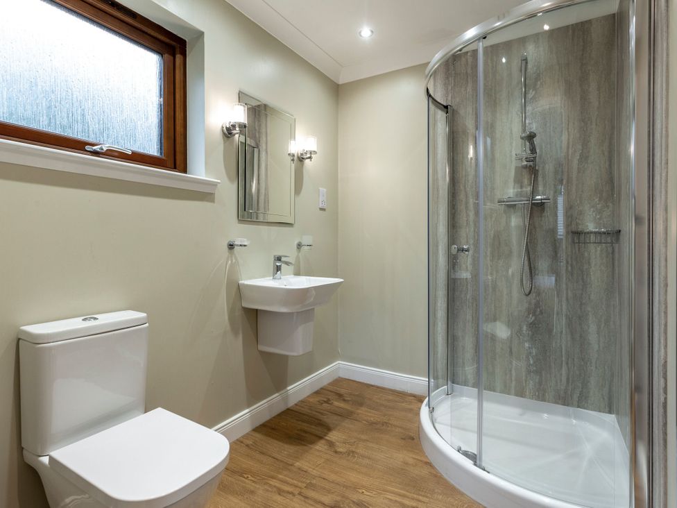 A bathroom with a toilet, sink, and shower at Galbraith Premier Spa in Dundee