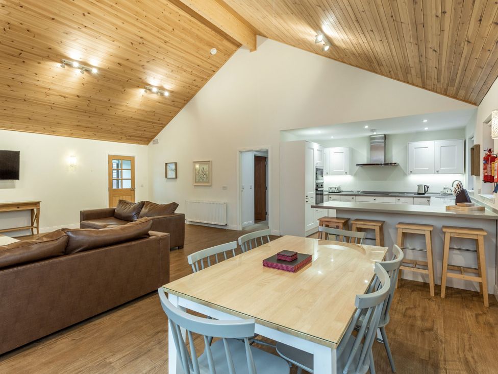 A living room with a sofa and dining table at Galbraith Premier Spa (Pet) Dundee