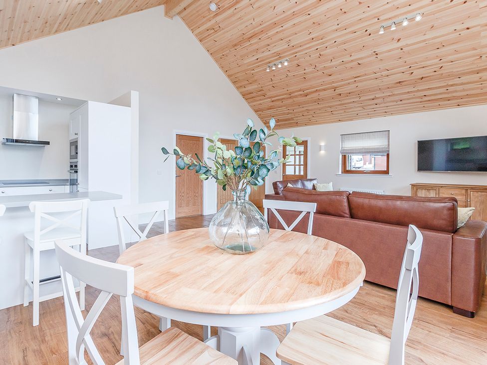 A living room with a table and chairs and couch at Galbraith Premier Spa (Pet) Dundee