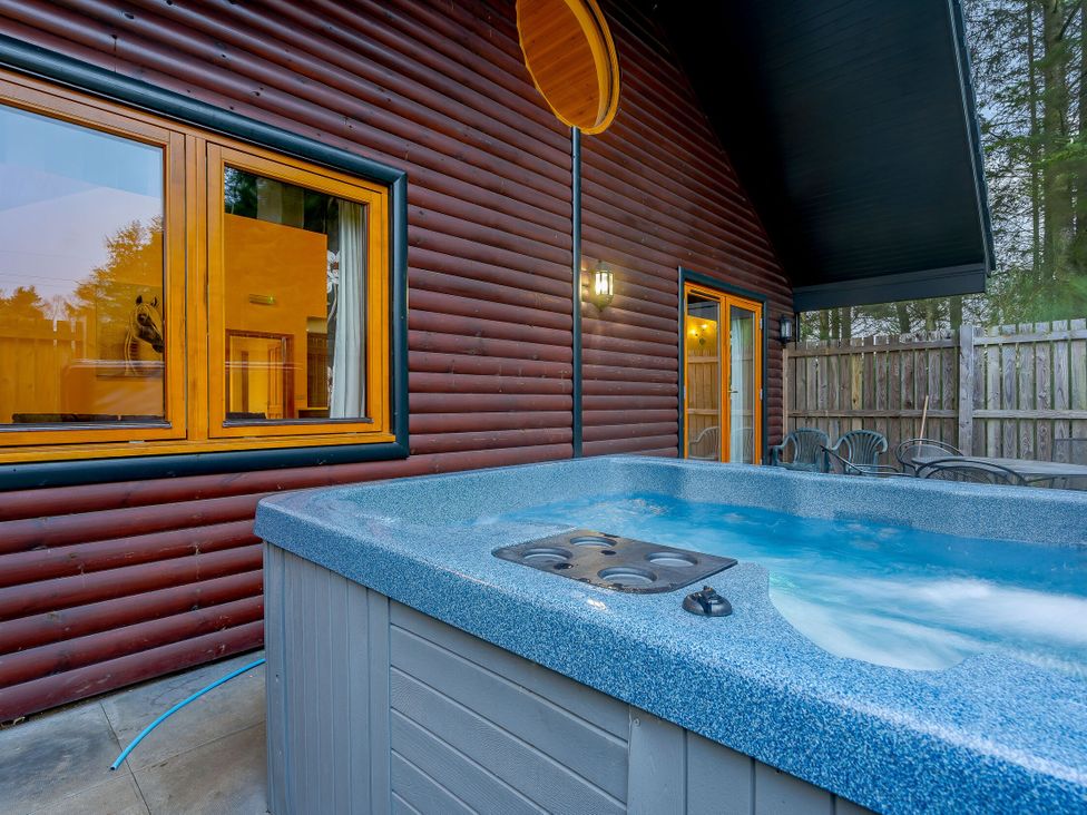 A hot tub on an outdoor patio at Osprey Spa Plus (Pet) in Dundee
