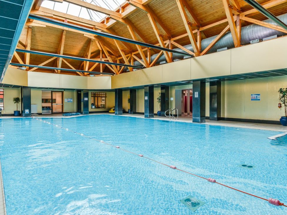 An indoor pool area with a water feature at Lochside Premier Spa in Dundee