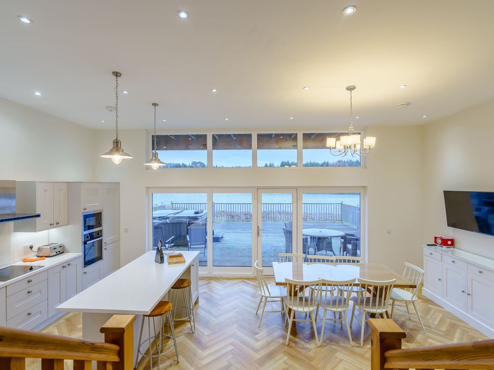 A kitchen featuring an island table and dining area at Lochside Premier Spa (Pet) Dundee