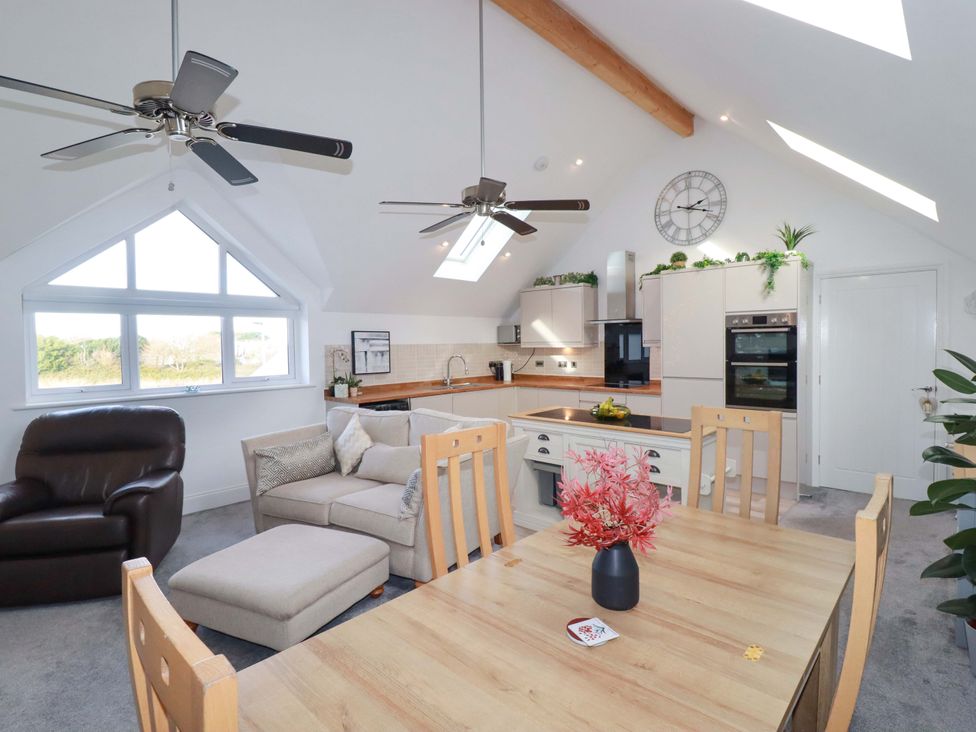 A living room with a sofa and dining area at 33 Fordh Tobmen St. Agnes