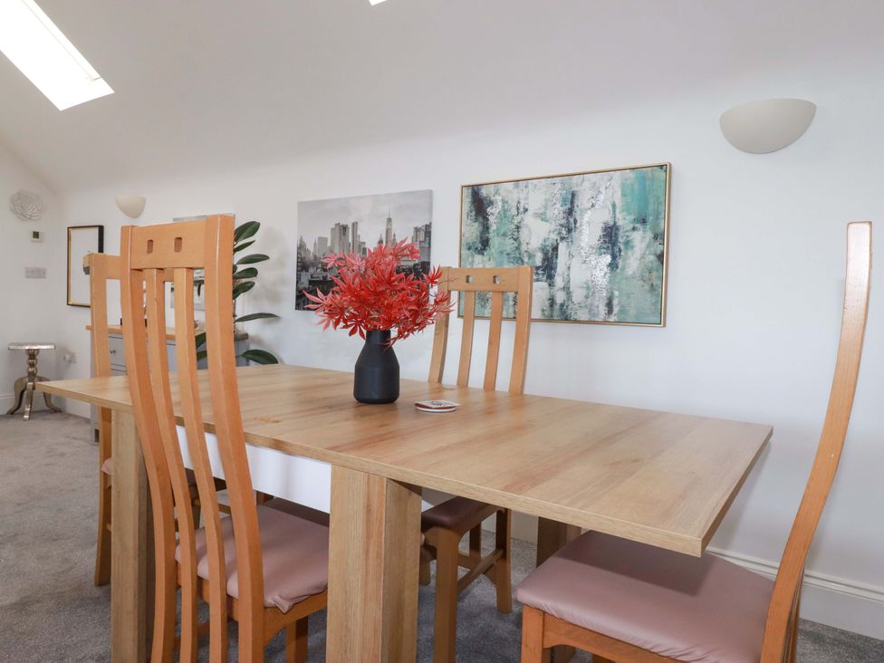 A dining room with a wooden table and chairs at 33 Fordh Tobmen St. Agnes