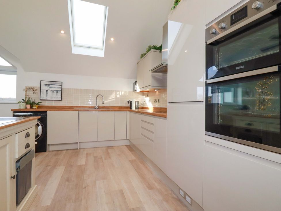 A kitchen with appliances and a skylight at 33 Fordh Tobmen St. Agnes