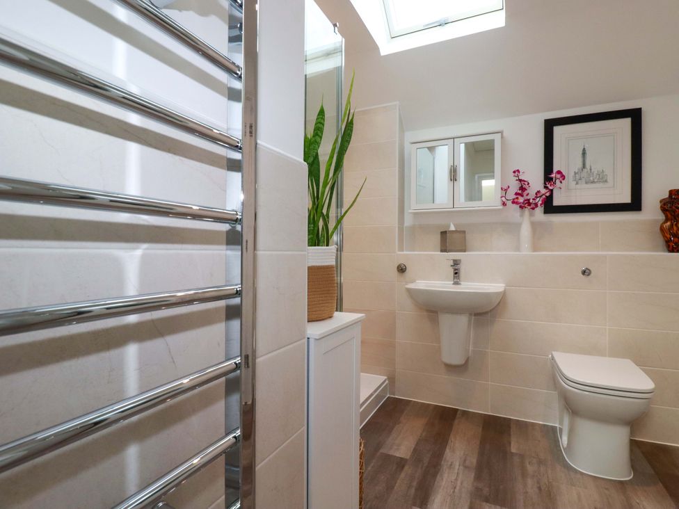 A bathroom with a towel radiator and sink at 33 Fordh Tobmen St. Agnes