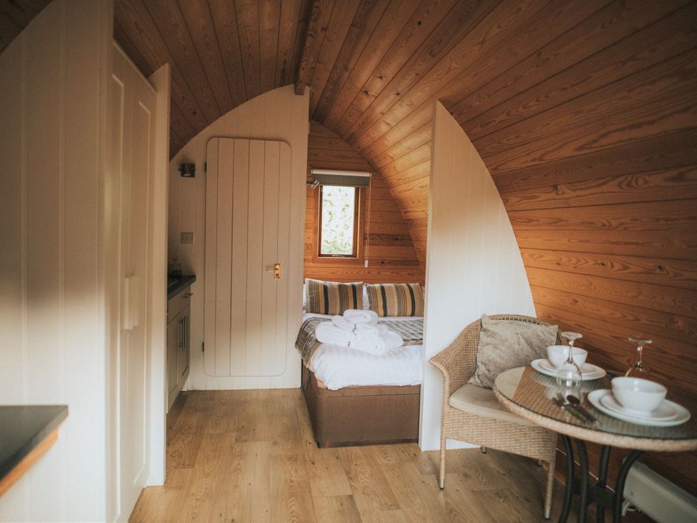 A room with a bed and a table at Garden Pod VIP in Waltham