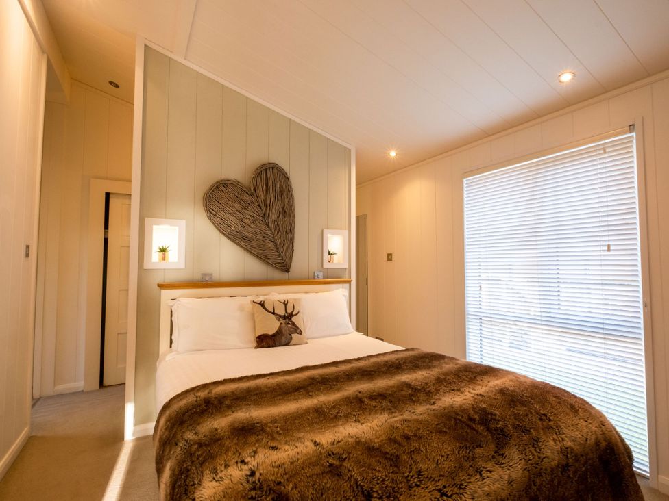 A bedroom with a bed and wall art at The Belfry in Waltham