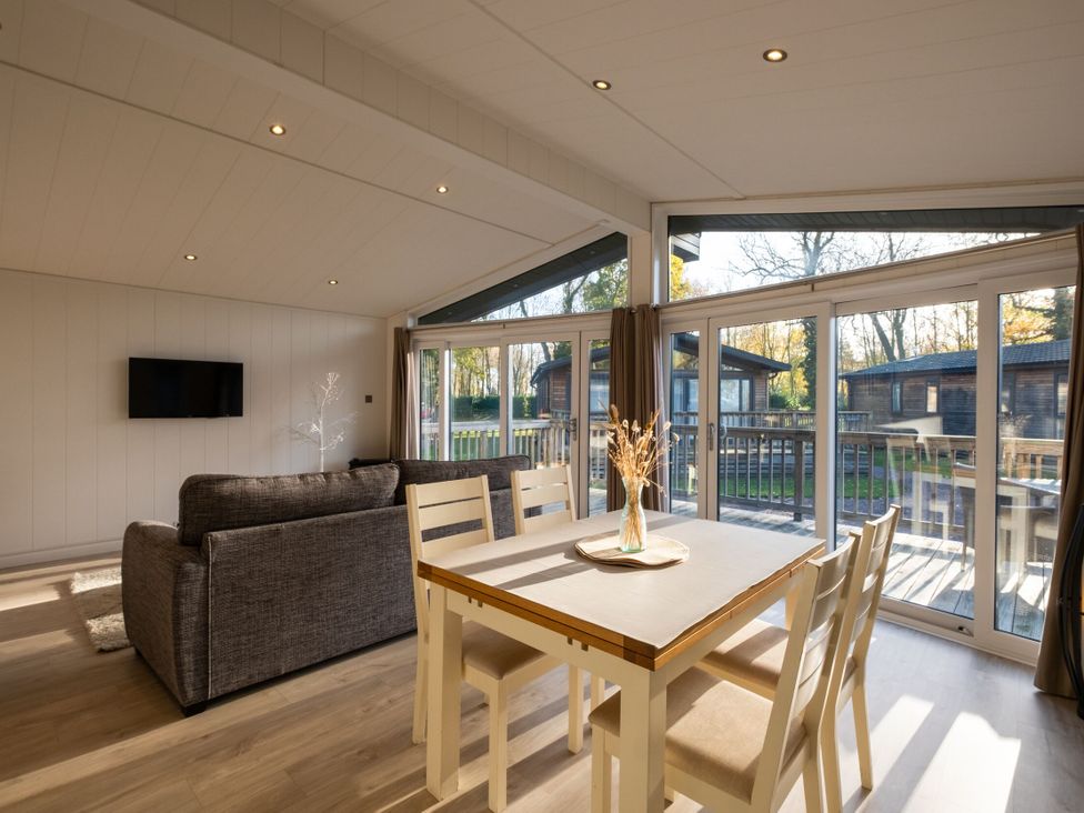 A living room with a dining table and sofa at Belfry in Waltham