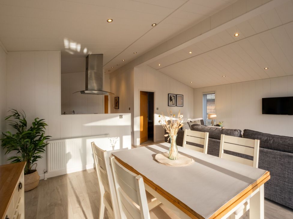 A dining room with a table and chairs at Belfry Waltham