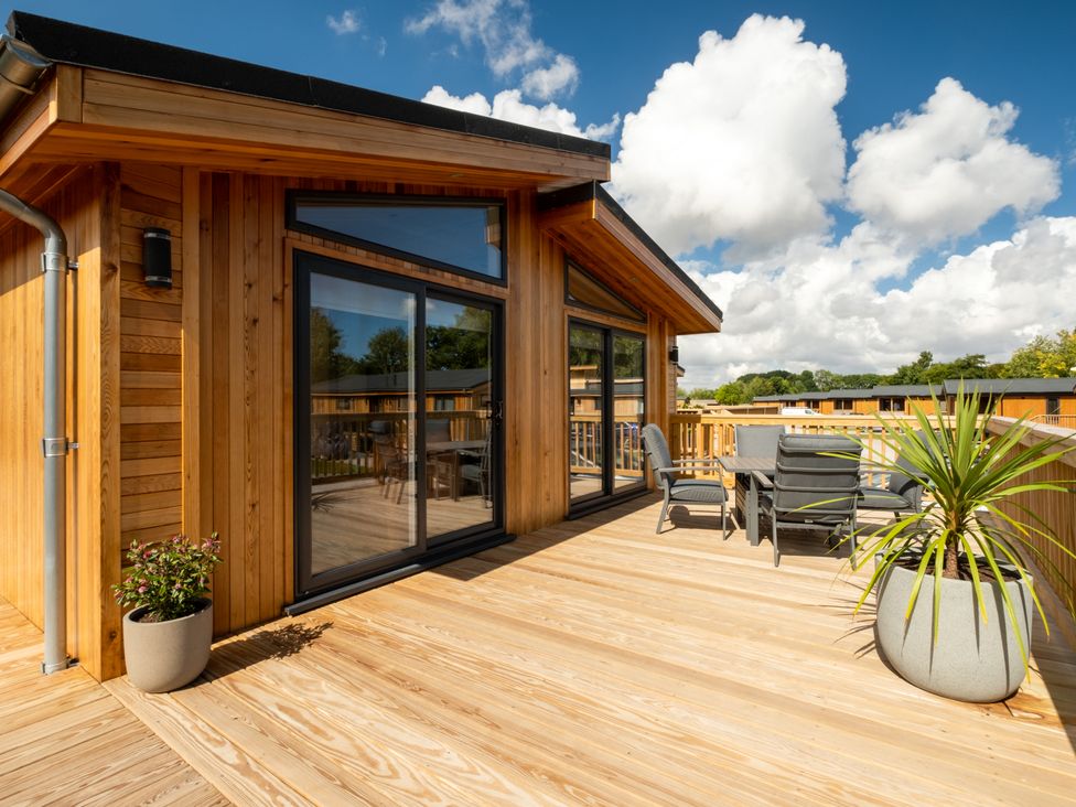 An outdoor deck with seating and plants at Moonlight Spa Luxury Waltham