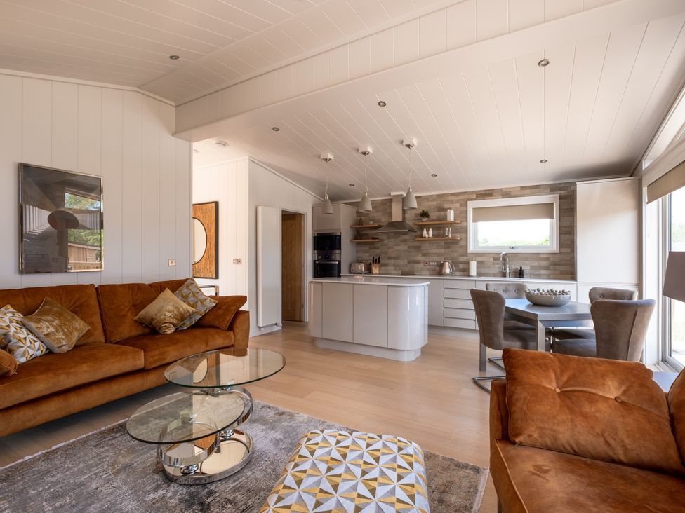 A living room with a kitchen island and dining area at Moonlight Spa Luxury in Waltham