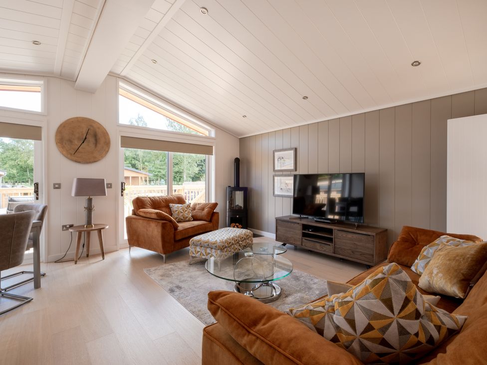 A living room with a television and sofa at Moonlight Spa Luxury in Waltham