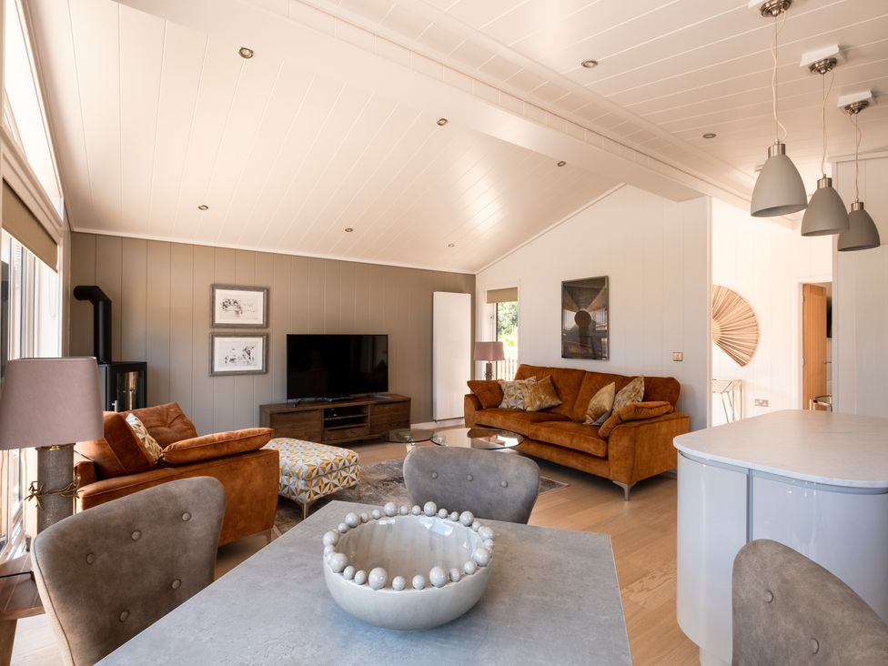 A living room with a sofa and television at Moonlight Spa Luxury Waltham