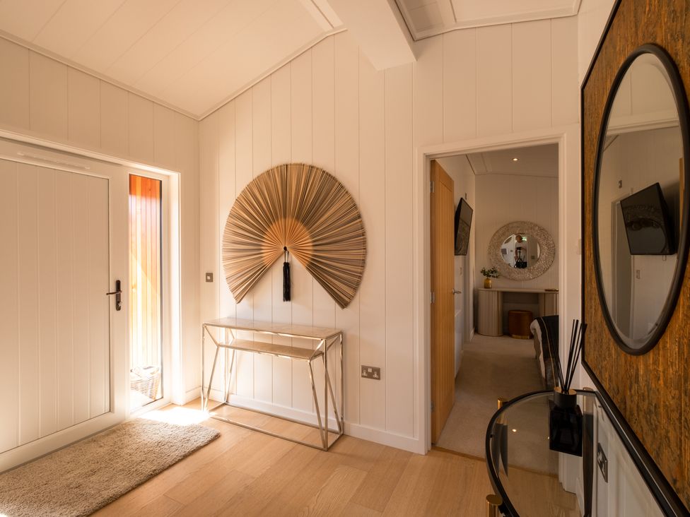 A hallway with a fan on the wall at Moonlight Spa Luxury in Waltham