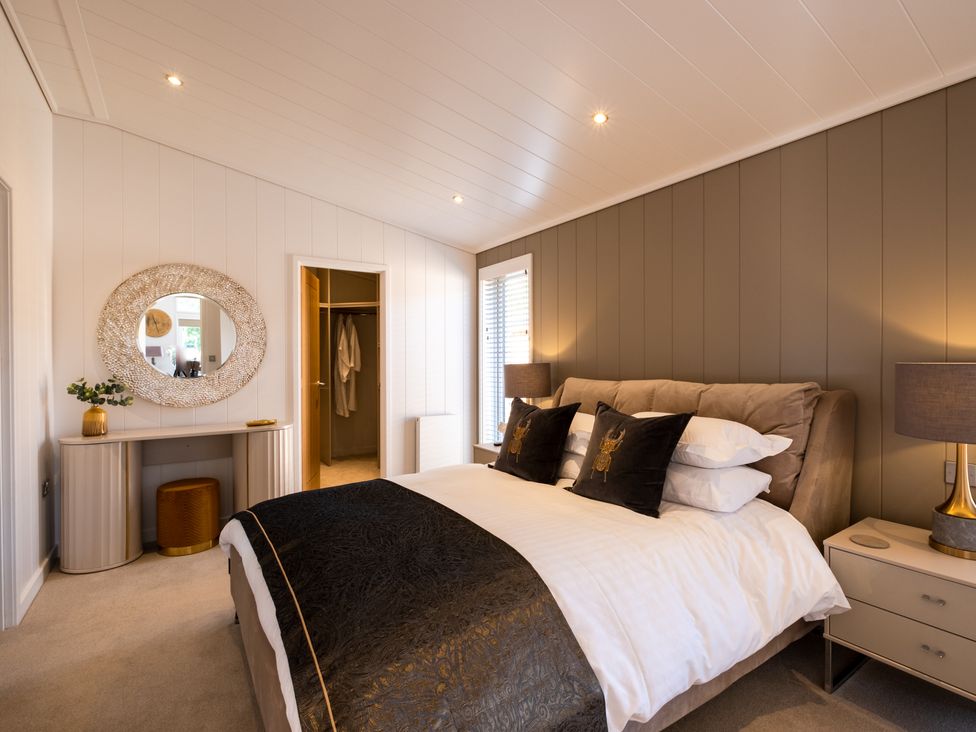 A bedroom with a bed and dresser at Moonlight Spa Luxury in Waltham