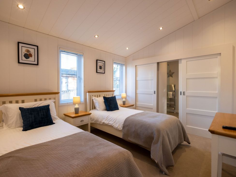 A bedroom with two beds and windows at Wentworth in Waltham