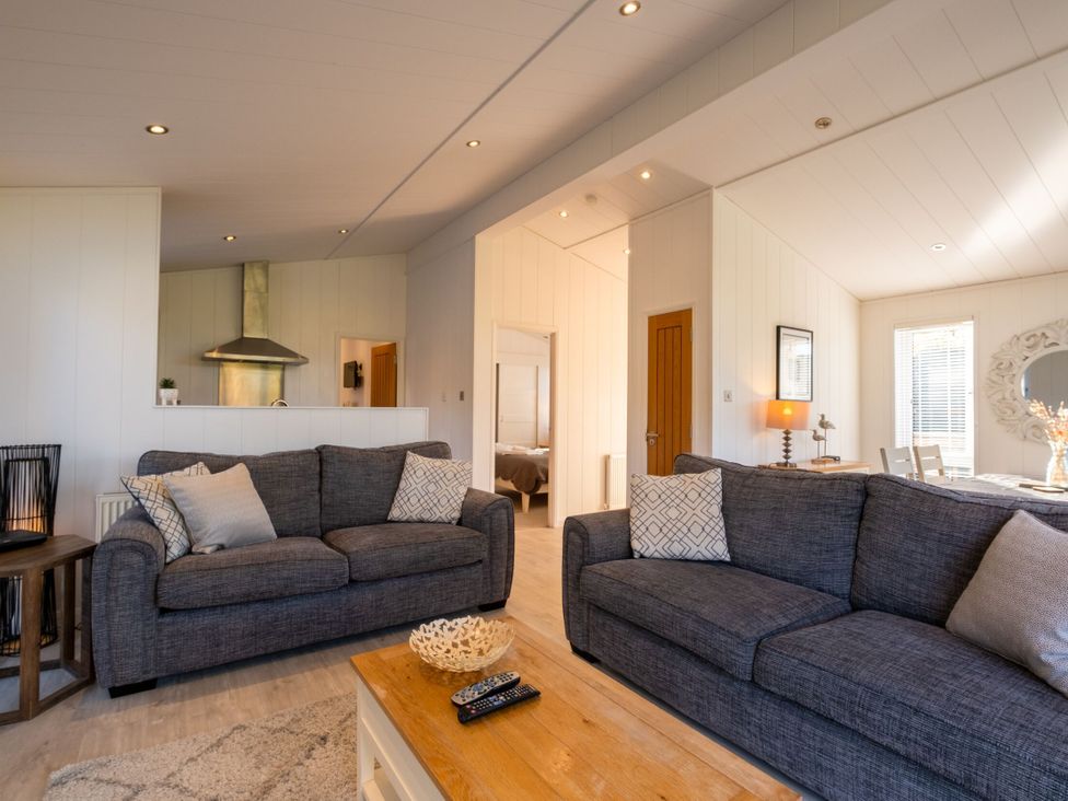 A living room with sofas and a dining area at Wentworth in Waltham