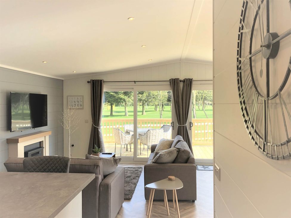 A living room with a television and sofa at Dream View in Waltham