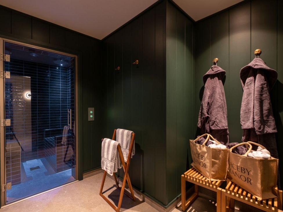 A sauna area with robes and towels at Dream View in Waltham