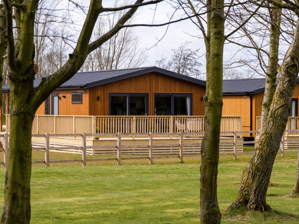 A wooden cabin with a deck at Royal View in Waltham