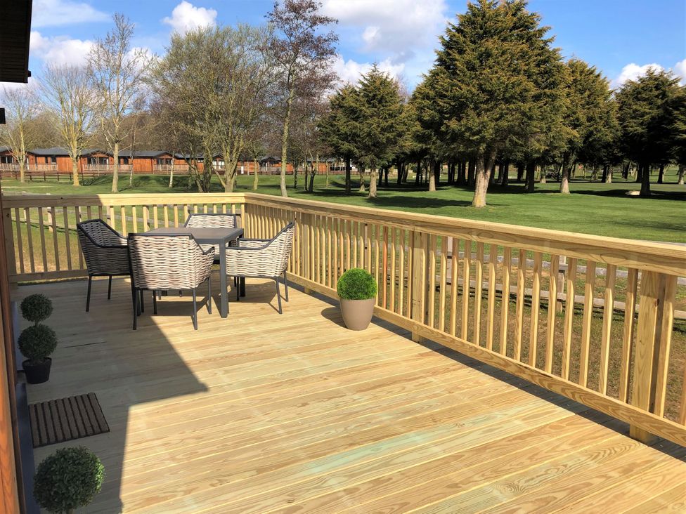 A deck with a table and chairs at Royal View in Waltham