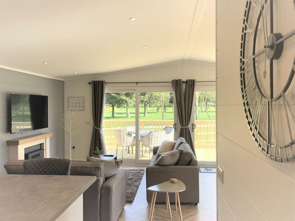 A living room with a sofa and television at Royal View in Waltham