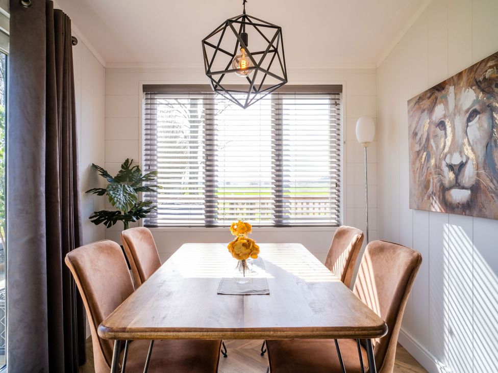 A dining room with a table and chairs at Goldfinch in Waltham