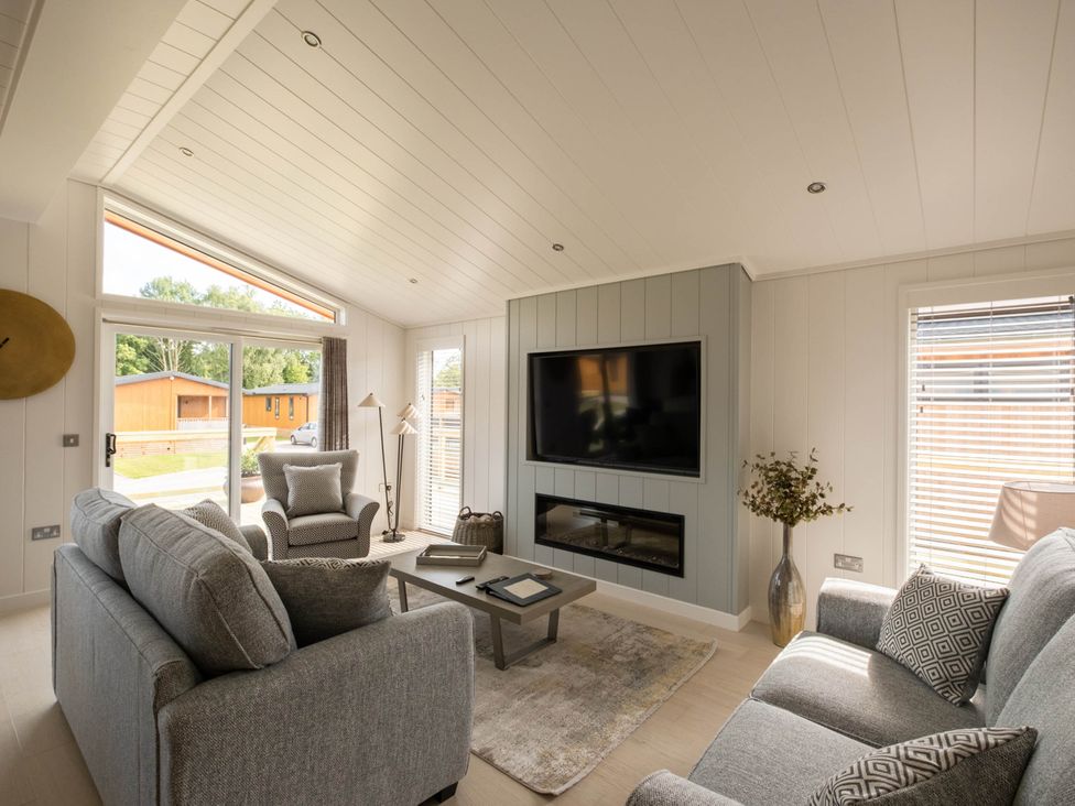 A living room with a sofa and television at The Luxury Hideaway in Waltham