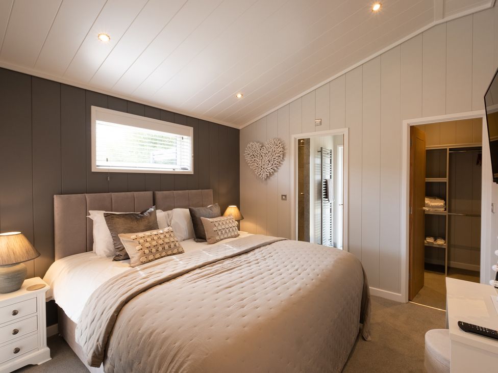 A bedroom with a bed and closet at The Luxury Hideaway in Waltham