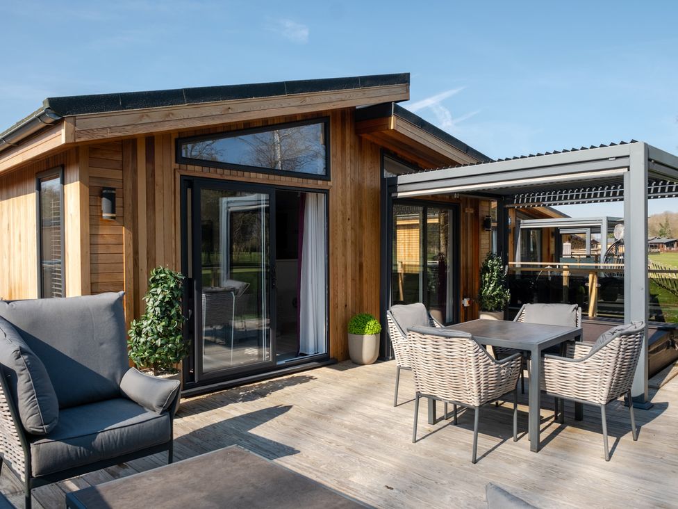 An outdoor area with a table and chairs at The Luxury Hideaway in Waltham